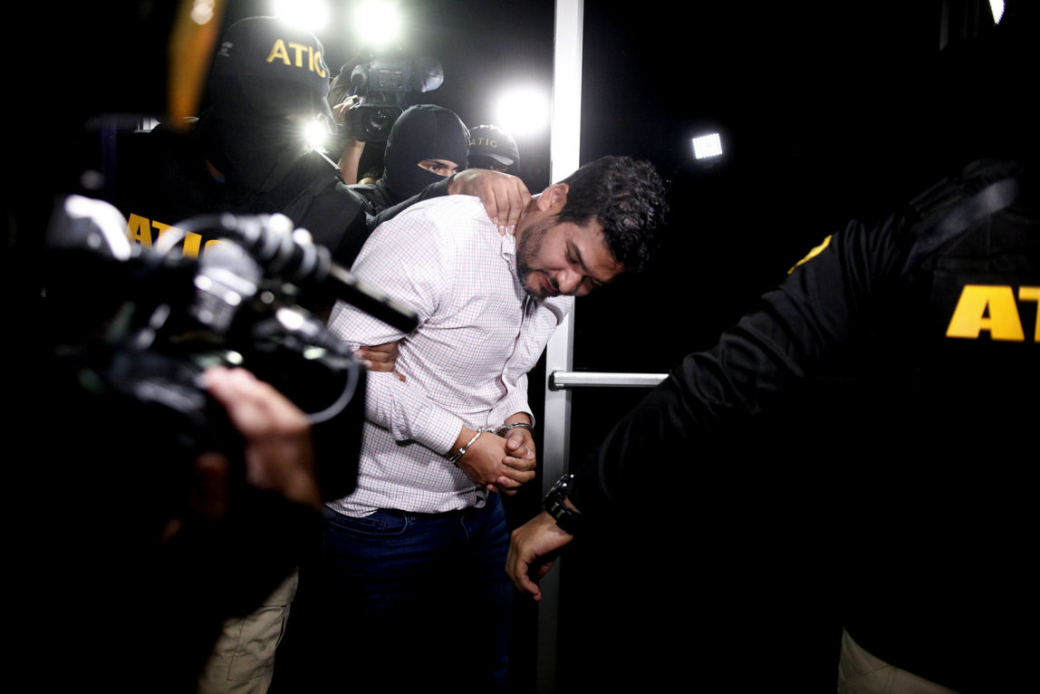 Roberto David Castillo is taken into custody by the police as he is walked to the Technical Investigation Agency in Tegucigalpa, Honduras, March 2, 2018. (AP/Fernando Antonio)