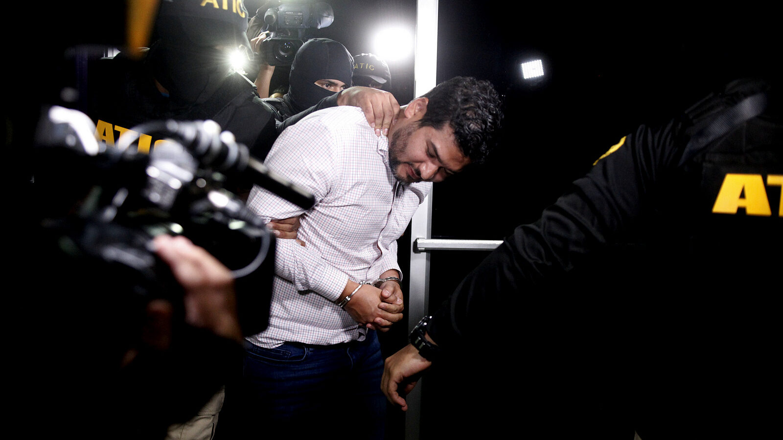Roberto David Castillo is taken into custody by the police as he is walked to the Technical Investigation Agency in Tegucigalpa, Honduras, March 2, 2018. (AP/Fernando Antonio)