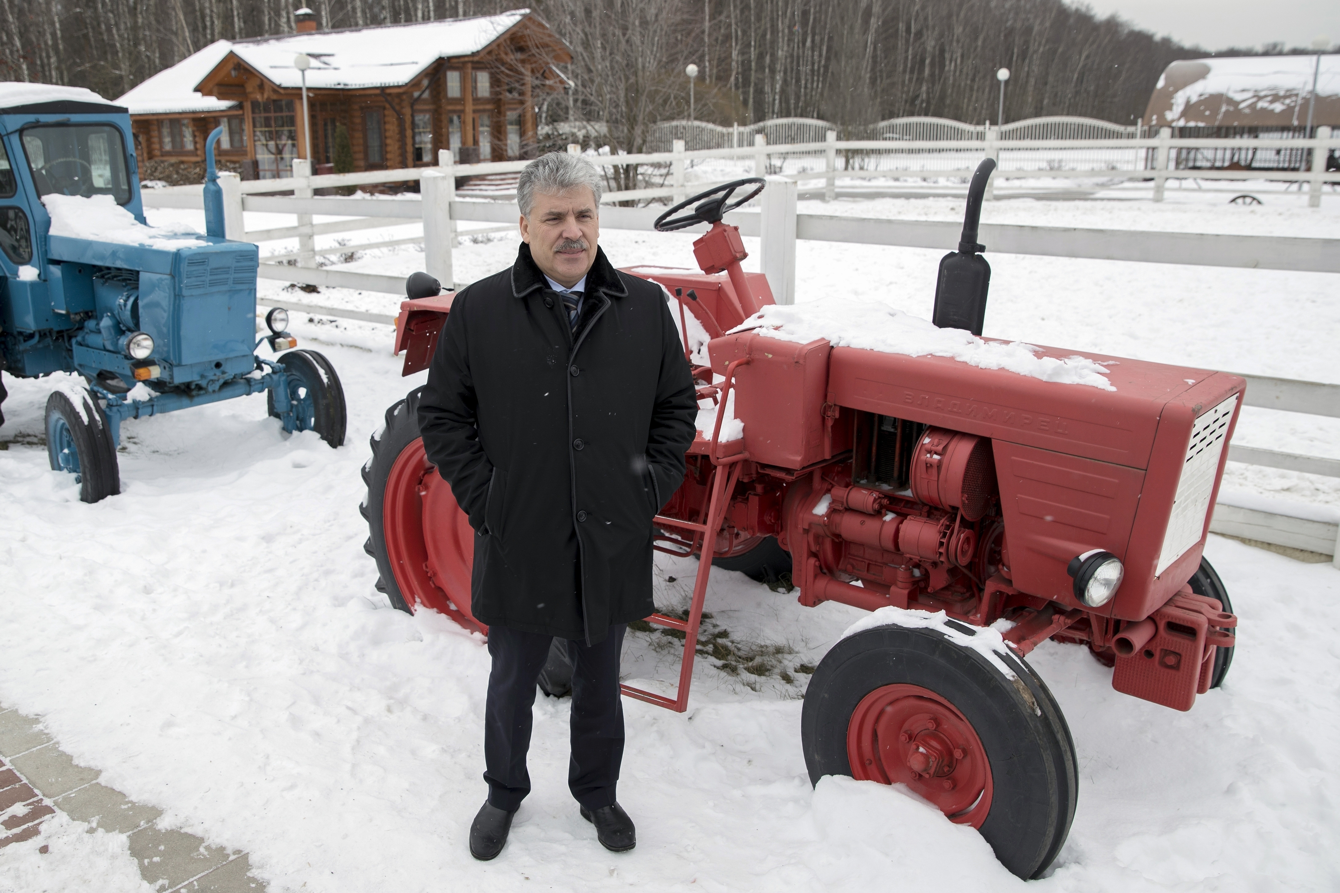 Communist Party candidate for the 2018 Russian presidential election Pavel Grudinin posea for a picture with old made Soviet tractors outside Moscow, Russia, Jan. 26, 2018. (AP/Pavel Golovkin)