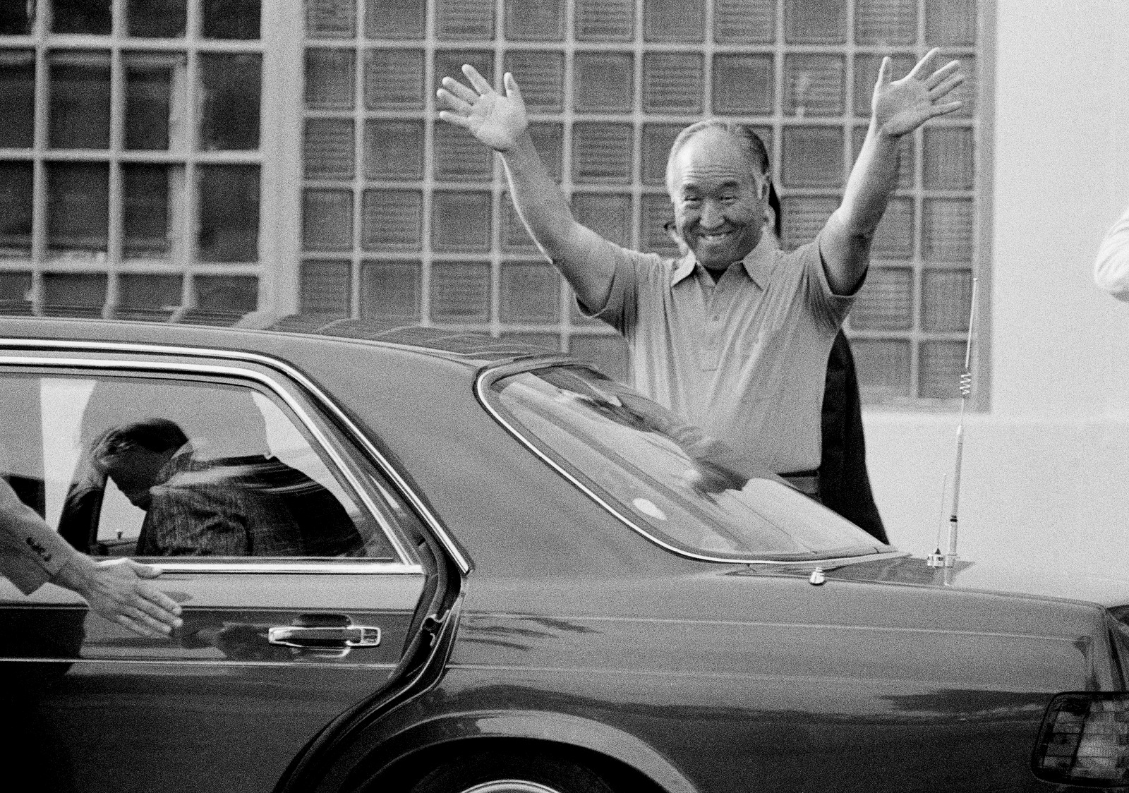 Rev. Sun Myung Moon smiles and waves as he left the Federal Correctional Institution in Danbury, July 4, 1985. Moon, who heads the Unification Church, was jailed last July on tax evasion charges. He left Danbury to serve the remainder of his sentence at a halfway house in Brooklyn, N.Y. (AP/Bob Child)