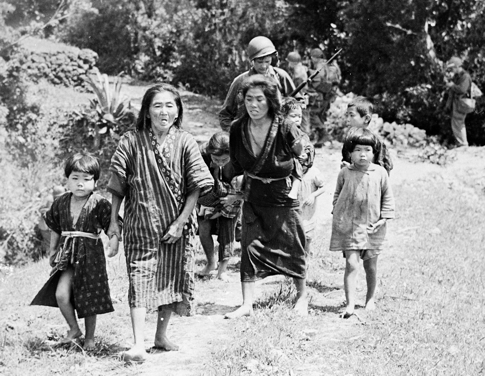 Japanese women and children are moved down a road in Okinawa shortly after American forces invaded Ryukyu island, April 6, 1945. (AP Photo)