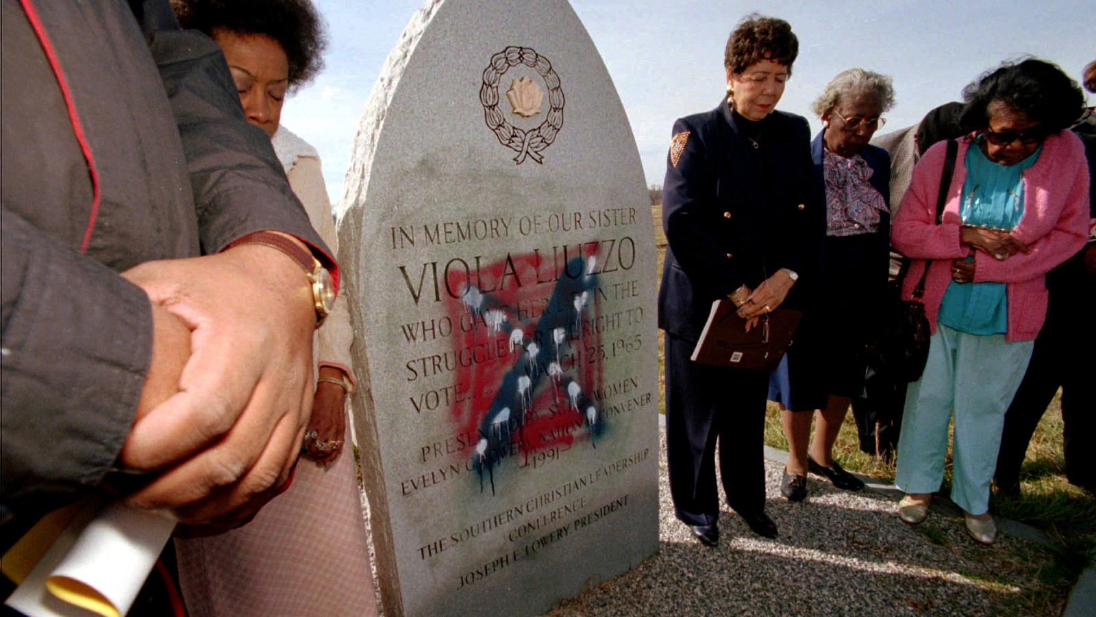 Southern Christian Leadership Conference/Women members and supporters gather in prayer around the defaced monument to civil rights worker Viola Liuzzo in Haneyville, Ala., Feb. 5, 1997. (AP/stf)