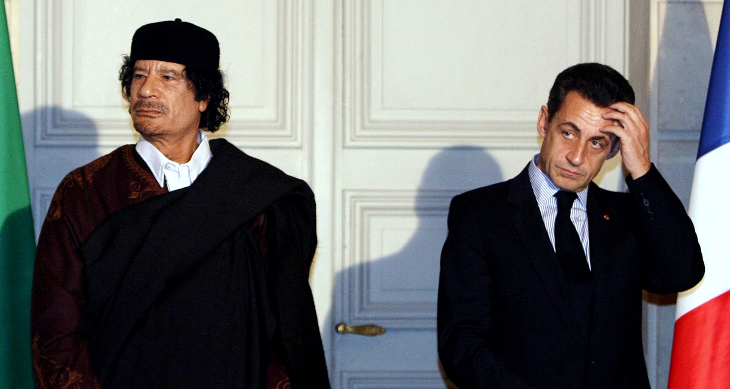 Former Libyan leader Moammar Gadhafi, left, and French President Nicolas Sarkozy, pose during a ceremony at the Elysee Palace in Paris in December, 2007. (Patrick Hertzog/AP)