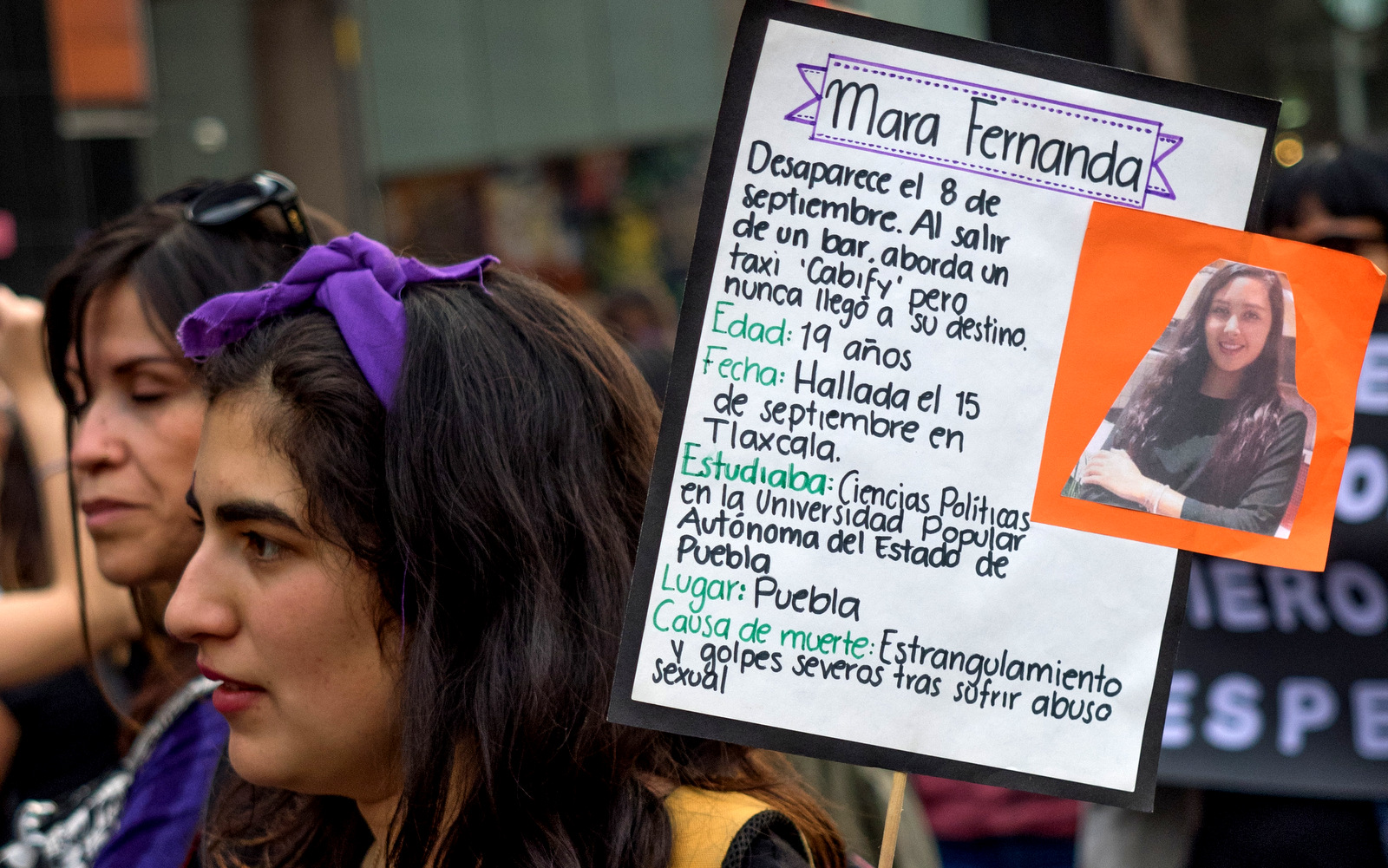 A young woman attending the International Women's Day in Mexico City holds a sign with the name and story of Mara Fernanda, a women allegedly killed by her cab driver in a case that caused reverberations throughout Mexico, March 8, 2018. (Photo: José Luis Granados Ceja/MintPress News)