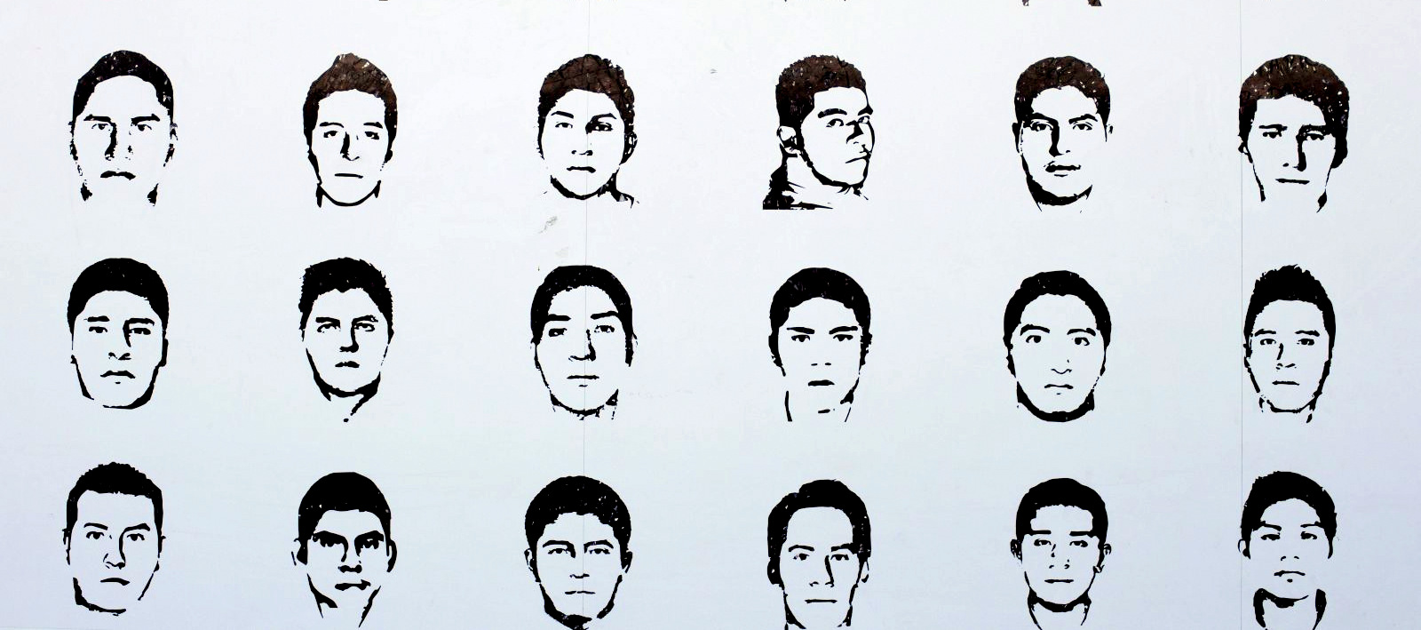 Portraits of missing students depicted on a billboard at a protest camp inside Mexico City's main square. (Rebecca Blackwell/AP)