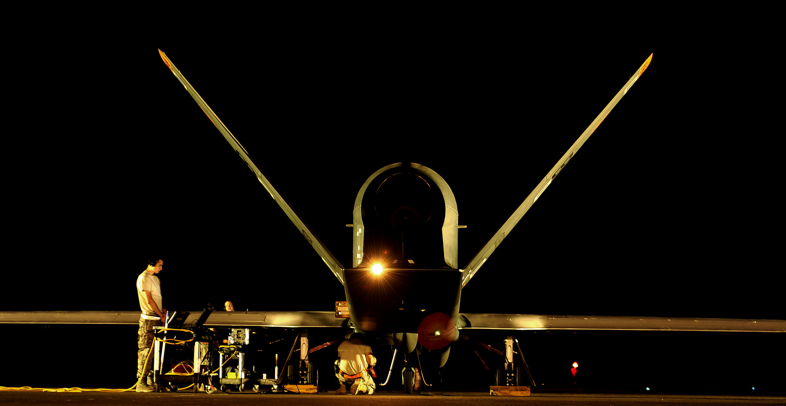 An RQ-4 Global Hawk gets all pre-flight checks accomplished from maintenance technicians before a mission while deployed at an air base in Southwest Asia. The (U.S. Air Force photo)