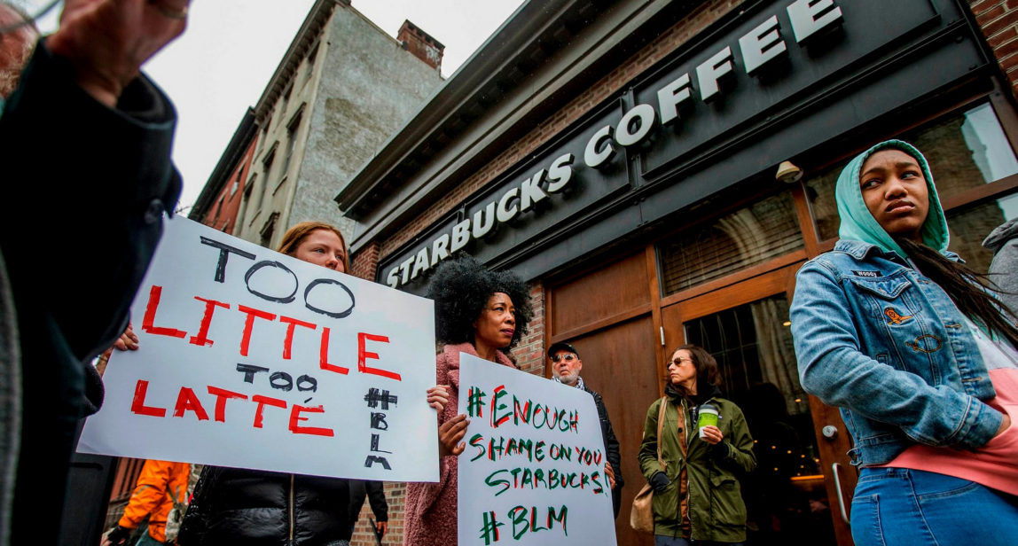 Protesters gather outside of a Starbucks in Philadelphia,, April 15, 2018, where two black men were arrested after employees called police to say the men were trespassing. (Michael Bryant/The Philadelphia Inquirer via AP)