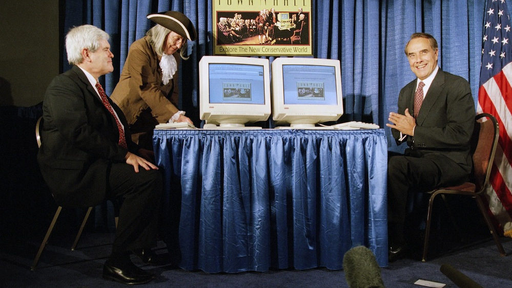 Senate Majority Leader Bob Dole of Kansas, right, and House Speaker Newt Gingrich of Ga., with the help of "Ben Franklin," introduce the first conservative Internet community "Town Hall," in Washington on June 29, 1995. 'Town Hall" was a joint venture of the Heritage Foundation and the National Review Magazine. (AP/Mark Wilson)