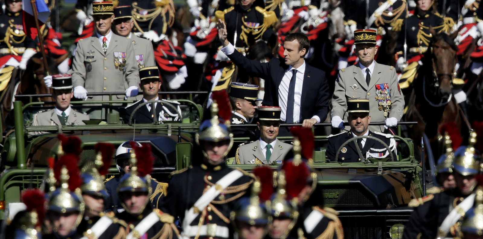 French President Emmanuel Macron, left, and Chief of the Defense Staff Gen. Pierre de Villiers, right, drive down the Champs Elysees avenue during Bastille Day parade in Paris, July 14, 2017. (AP/Markus Schreiber)