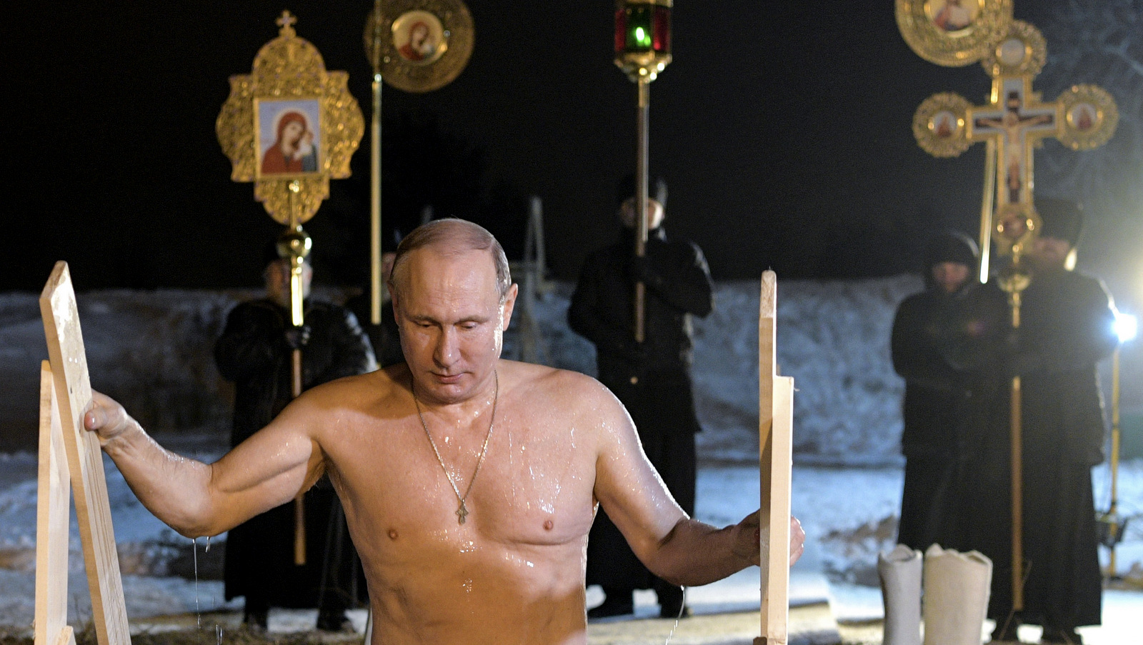 Russian President Vladimir Putin bathes in ice-cold water on Epiphany neat St. Nilus Stolobensky Monastery on Lake Seliger in Svetlitsa village, Russia, Jan. 19, 2018. (Alexei Druzhinin, Sputnik via AP)