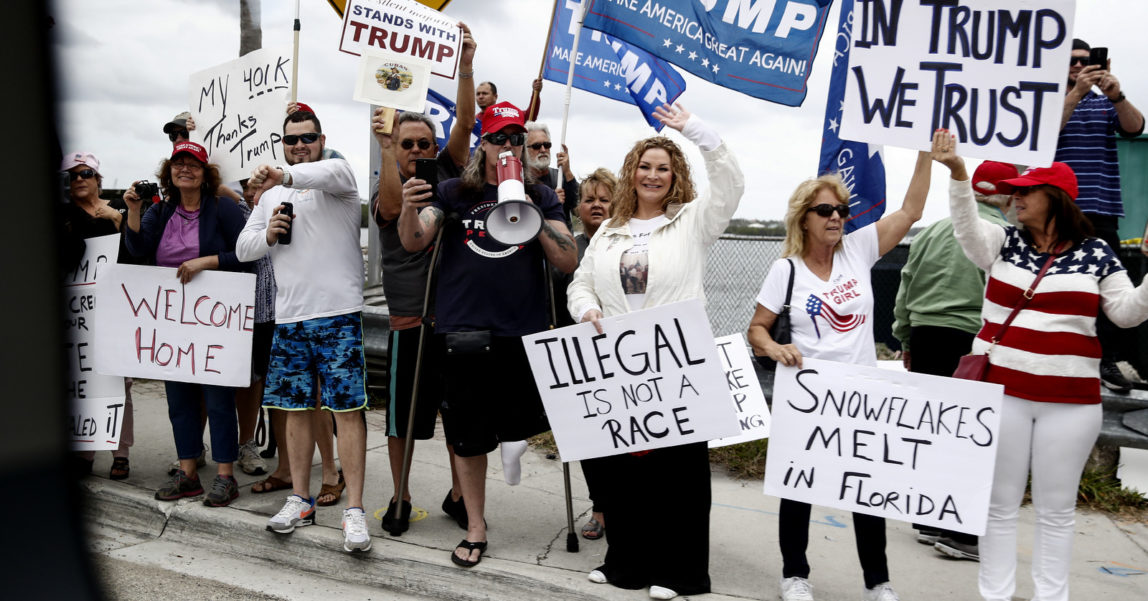 A group of President Donald Trump supporters is seen from the media van traveling in the president's motorcade en route to his Mar-a-Lago estate in Palm Beach, Fla., Feb. 3, 2018. (AP/Carolyn Kaster)