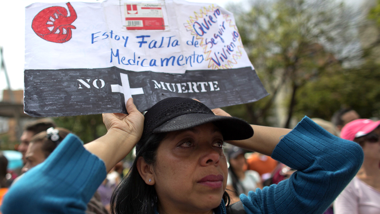 Carmen Vargas holds a sign with a message in Spanish: "I'm short of medication. I want to keep living. No more deaths.", during a protest against medical shortages, in Caracas, Venezuela, Feb. 8, 2018. (AP/Ariana Cubillos)