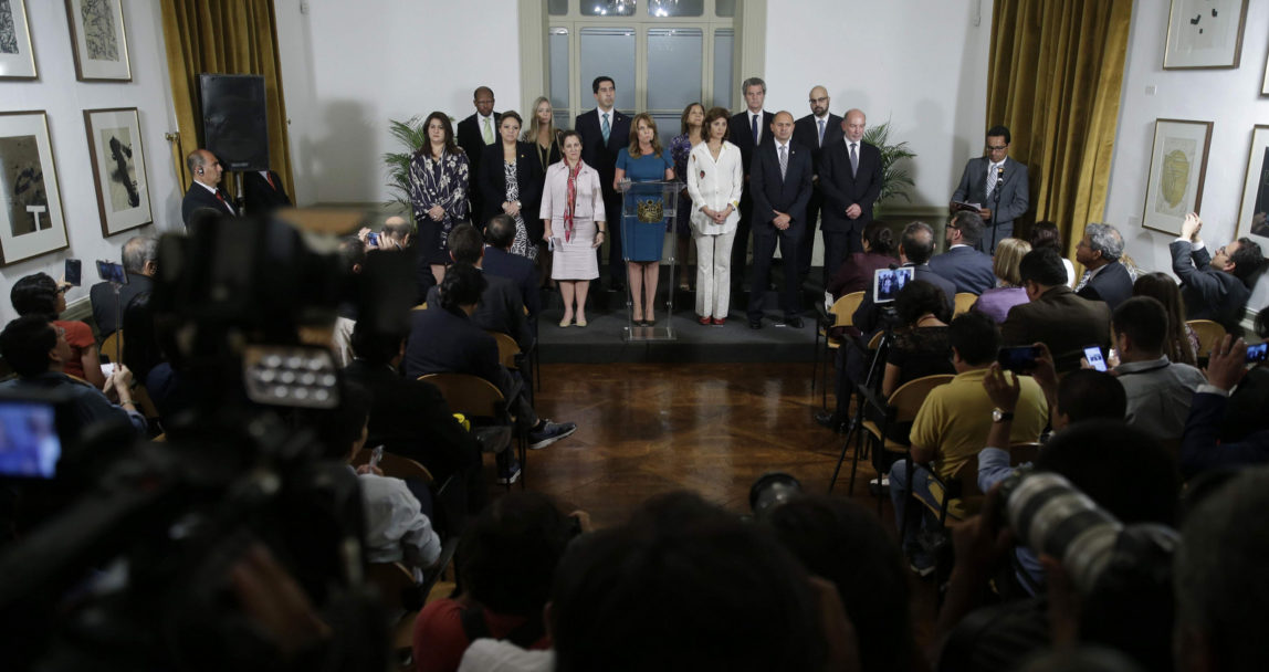The press covers Peru's Foreign Minister Cayetano Aljovin statement, as she stands with other Foreign Ministers of the Lima Group after a private meeting concerning Venezuela in Lima, Peru, Tuesday, Feb. 13, 2018. The Lima Group met to weigh further action against Venezuelan President Nicolas Maduro's administration after it unilaterally set the end of April as the date for elections, over the protest of the opposition. (AP Photo/Martin Mejia)
