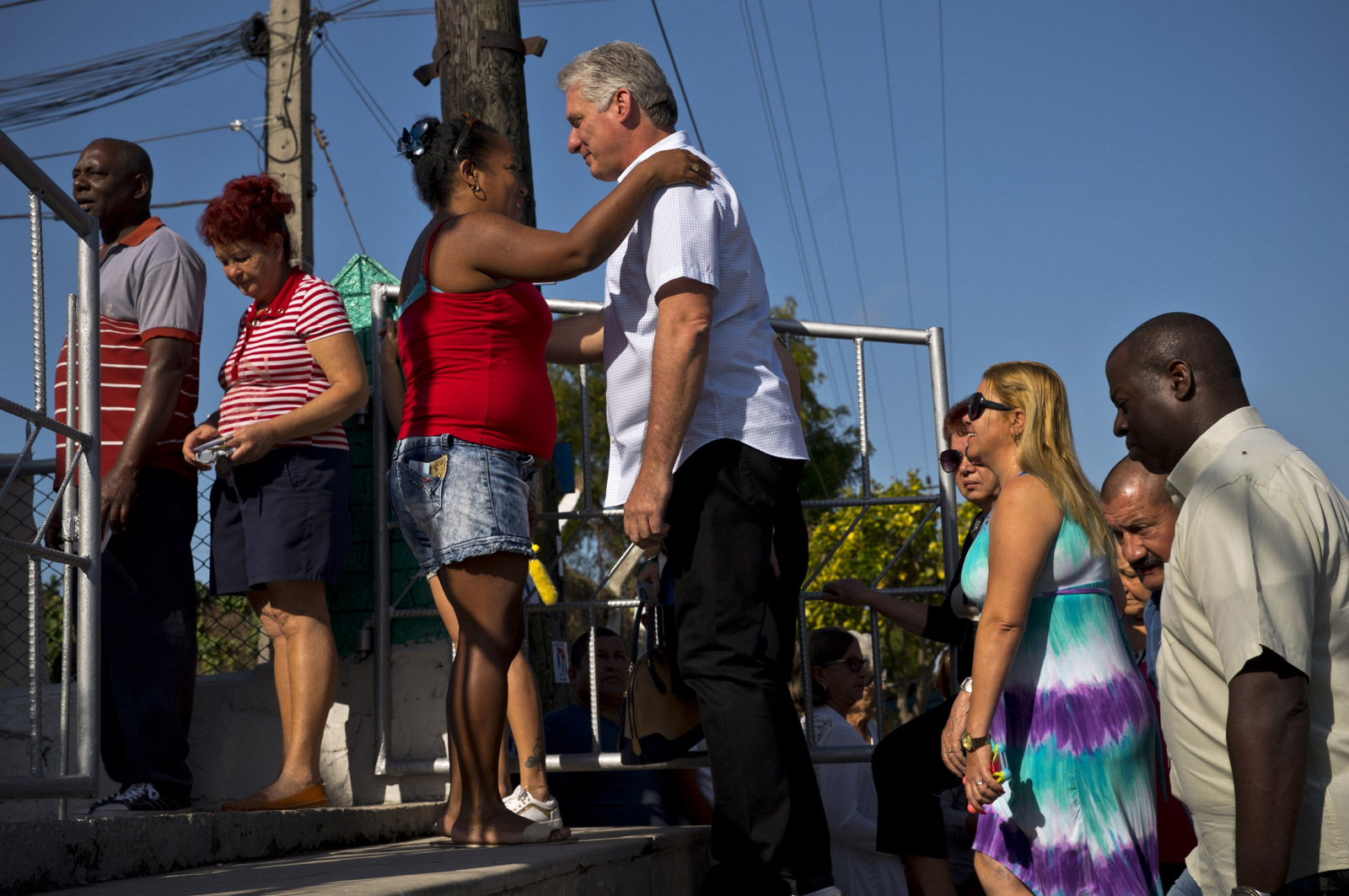 Cuba's Vice President Miguel Diaz-Canel, center, speaks with a woman as he waits with voters at a polling station during elections for national and provincial representatives for the National Assembly in Santa Clara, Cuba, March 11, 2018. (AP/Ramon Espinosa)