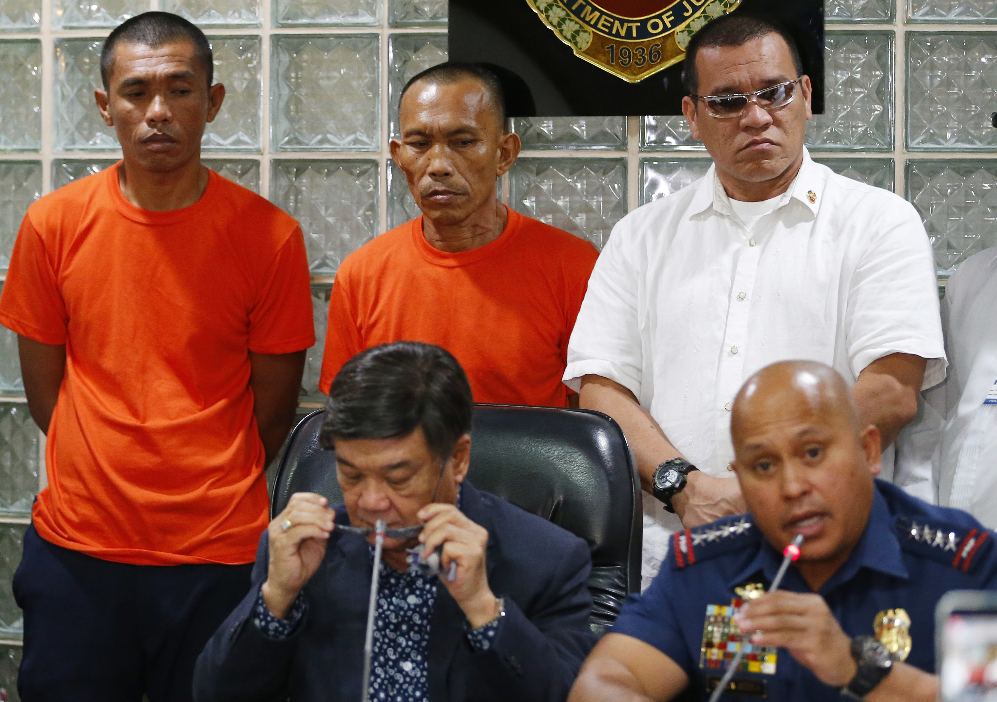 Two suspected Abu Sayyaf militants are presented to the media during a news conference at the National Bureau of Investigation headquarters, March 12, 2018 in Manila, Philippines. In their press statement, the two were arrested two weeks ago in Zamboanga, southern Philippines and were allegedly involved in kidnappings in 2001 and 2002 including that of American missionaries Martin and Gracia Burnham. (AP Photo/Bullit Marquez)