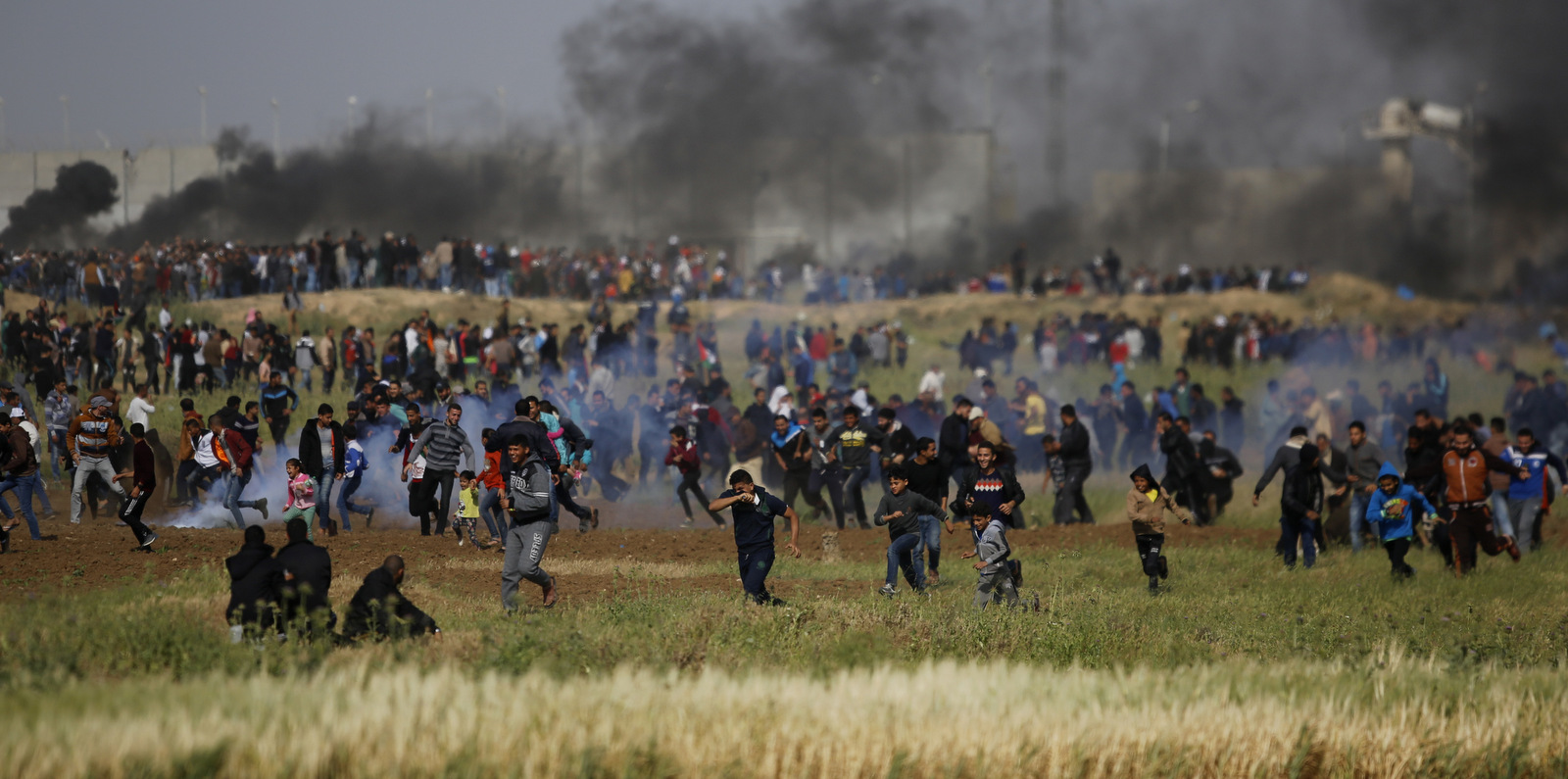 Teargas canisters fired from Israeli drones fall on Palestinians during a demonstration near the Gaza Strip border with Israel, in eastern Gaza City, Friday, March 30, 2018. (AP/Hatem Moussa)