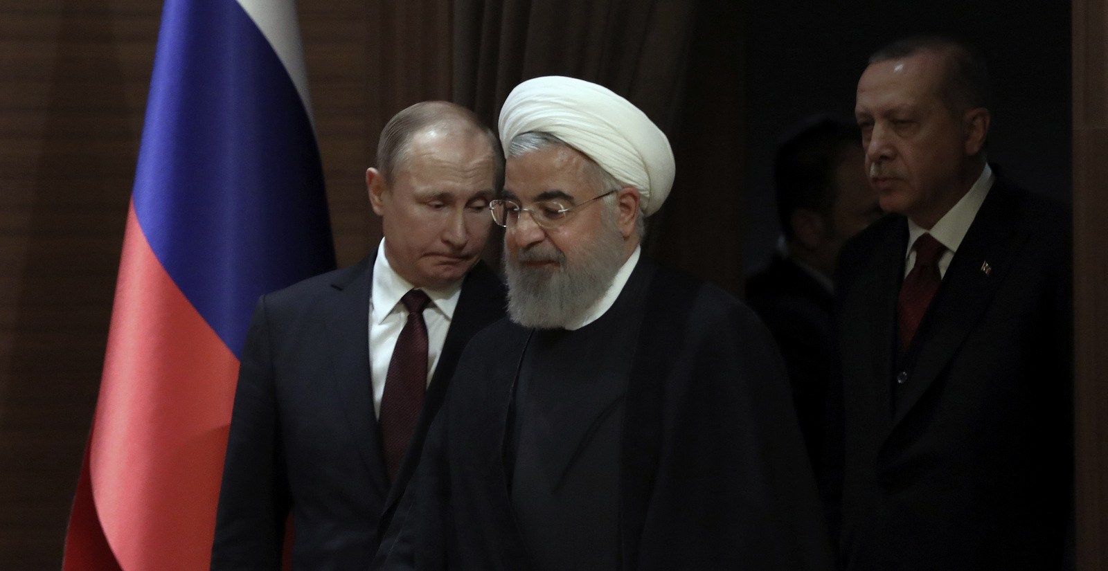 Iran's President Hassan Rouhani, front, Russia's President Vladimir Putin, left, and Turkey's President Recep Tayyip Erdogan arrive for a joint press conference in Ankara, Turkey, Wednesday, April 4, 2018. The leaders of Russia, Turkey and Iran say they stand against "separatist" agendas that would undermine Syria's sovereignty and territorial integrity. (AP Photo/Burhan Ozbilici)