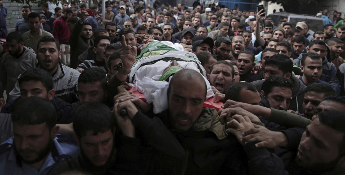 Palestinian mourners carry the body of 23-year-old Mojahid al-Khodari, who was killed early Thursday morning by an Israeli airstrike, during his funeral in Gaza City, April 5, 2018. A second man died from wounds sustained in a mass protest along the Israeli border. The fatalities bring to 21 the number of people killed in confrontations in the volatile area since last week. (AP/Khalil Hamra)