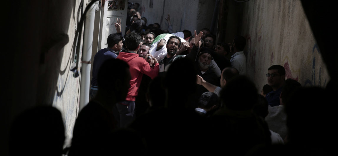 Relatives of a Palestinian Iman who was shot and killed Friday by Israeli troops during the ongoing protest along the Gaza Strip border with Israel, carry his body to the family house during his funeral in Gaza City, April 14, 2018. (AP/Khalil Hamra)