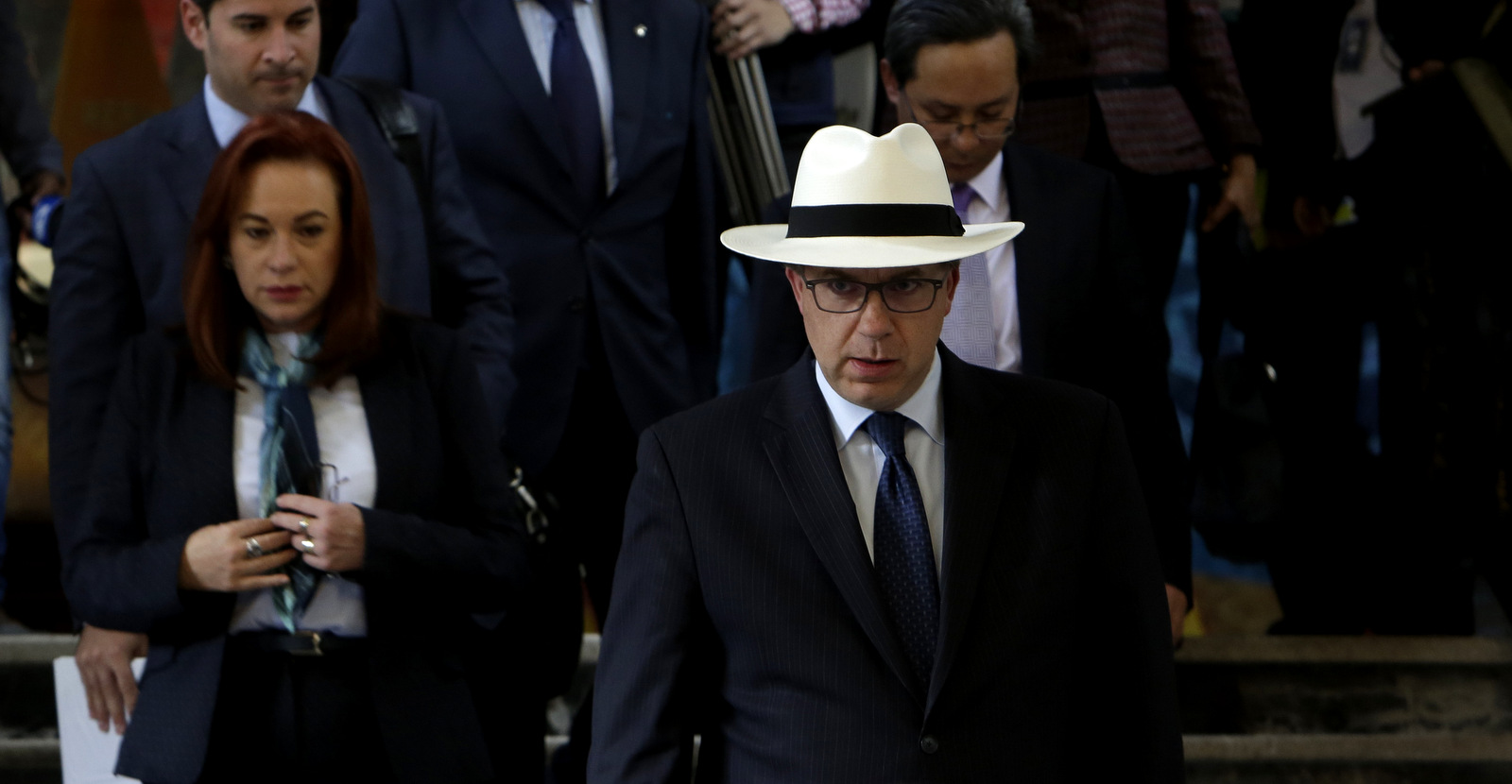United States ambassador Todd Chapman (wearing white hat) and others accompanied by Ecuador's Foreign Minister Fernanda Espinosa, left, leave the government palace after a meeting where the ambassadors showed their support for Ecuador's government in view of the recent events on the border between Ecuador and Colombia, in Quito, Ecuador, April 17, 2018. (AP/Dolores Ochoa)