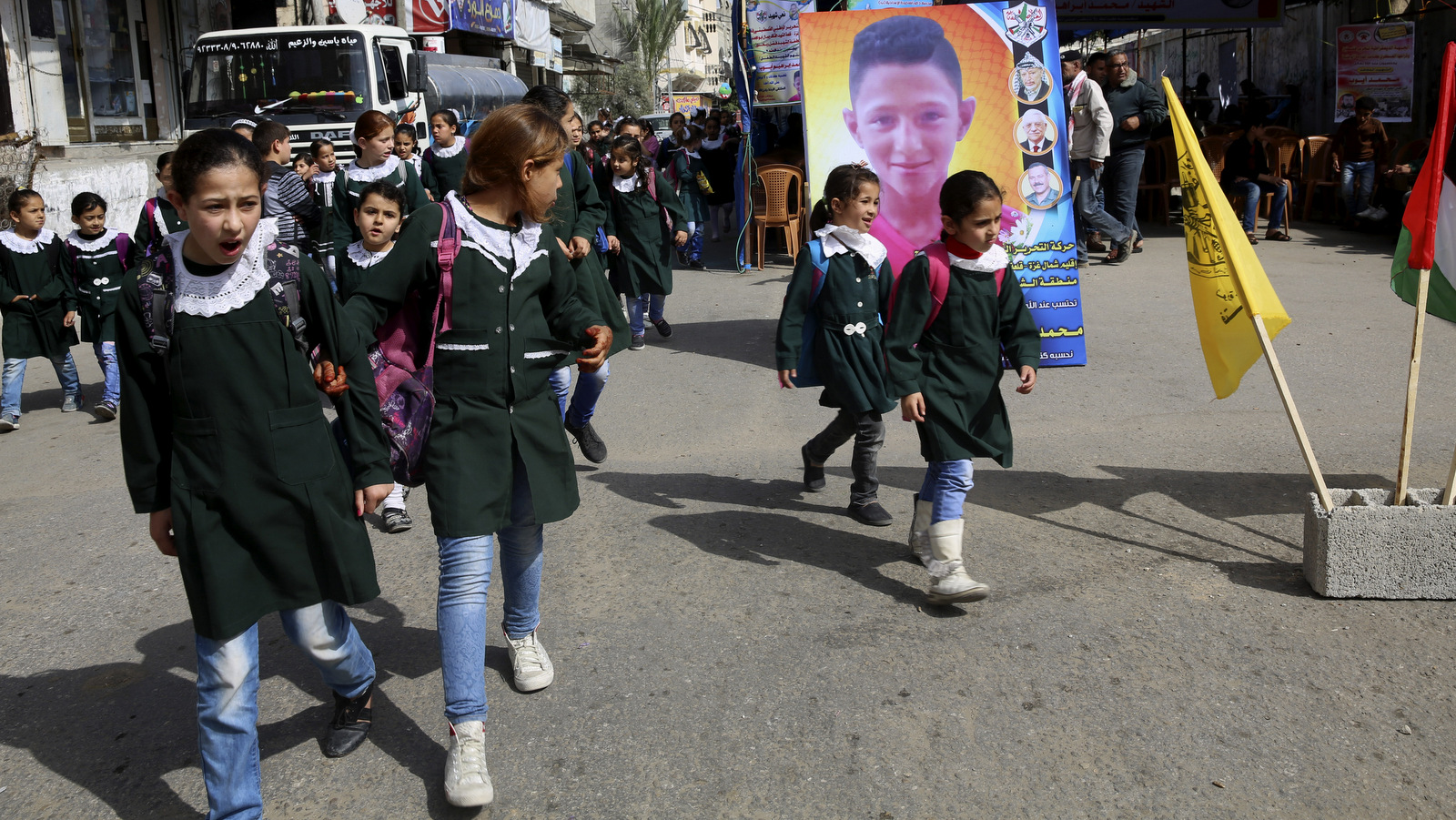 School girls look while pass the house morning of Mohammed Ayyoub, 14, who was killed by Israeli soldiers during a protest on Gaza's border with Israel, east of Jebaliya,, April 21, 2018. (AP/Adel Hana)