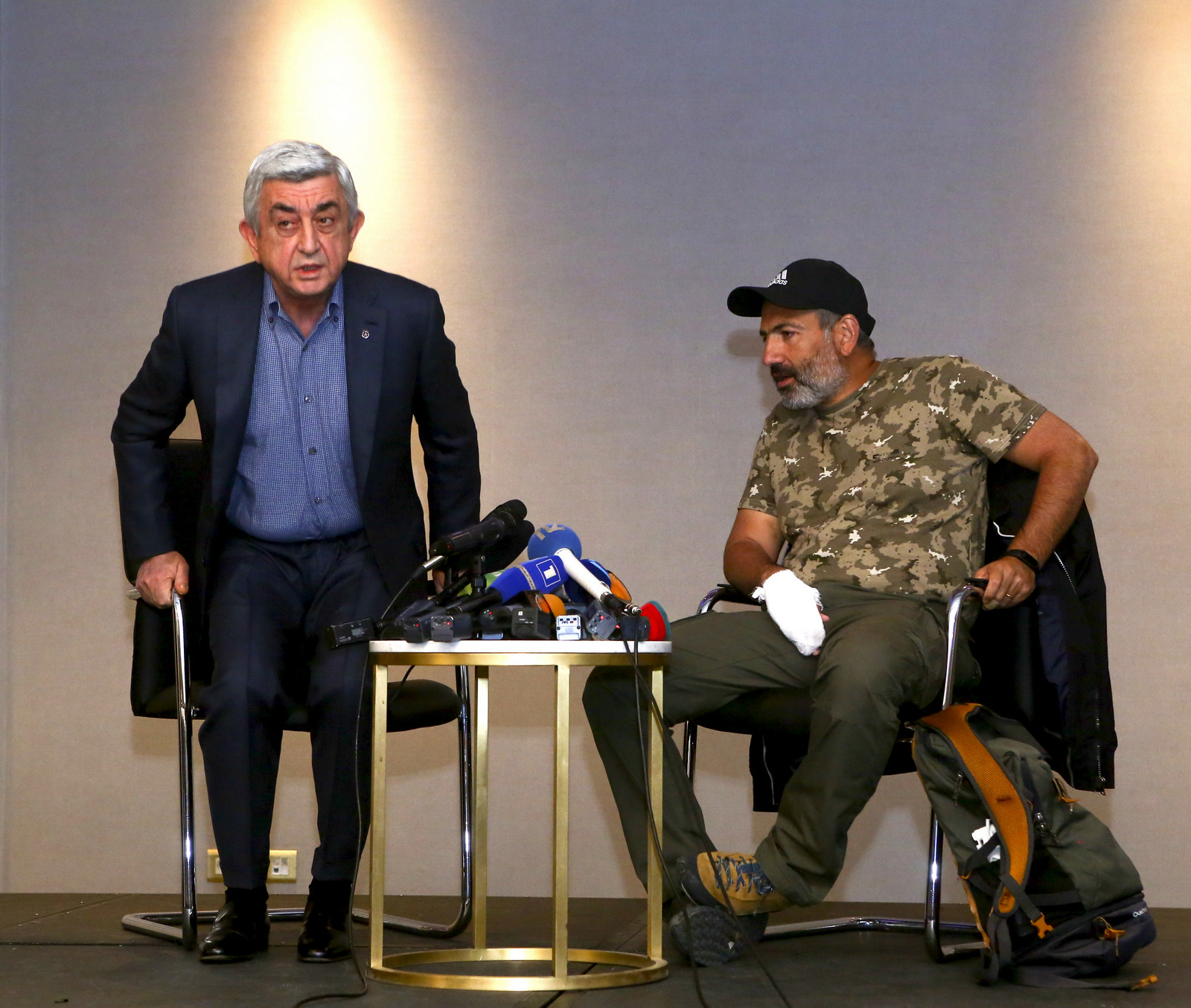 Armenian President Serzh Sargsyan, left, leaves a meeting with protest leader Nikol Pashinian, right, in Yerevan, Armenia. Armenian Prime Minister Serzh Sargsyan has resigned, April 22, 2018. (Hrant Khachatryan/PAN /AP)