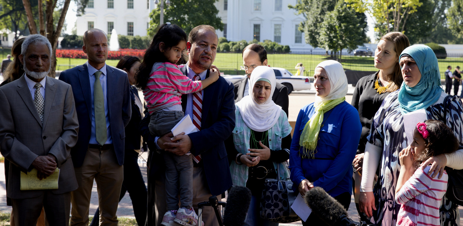 Zaher Sahloul, with the Syrian American Medical Society and American Relief Coalition for Syria speaks to media standing with Syrian refugees in Lafayette Square across from the White House in Washington, Sept. 16, 2015, to call on the Obama Administration to do more to address the ongoing crisis in Syria. (AP/Carolyn Kaster)