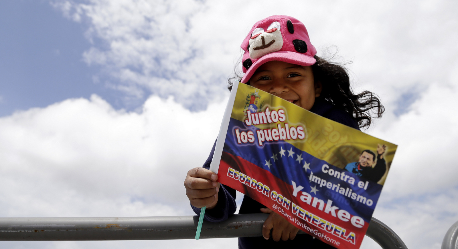A girl holds a Venezuelan flag as UNASUR's Foreign Ministers arrive to participate in the UNASUR regional foreign ministers meeting to discuss the situation in Venezuela, in Quito, Ecuador, Saturday, March 14, 2015. (AP/Dolores Ochoa)