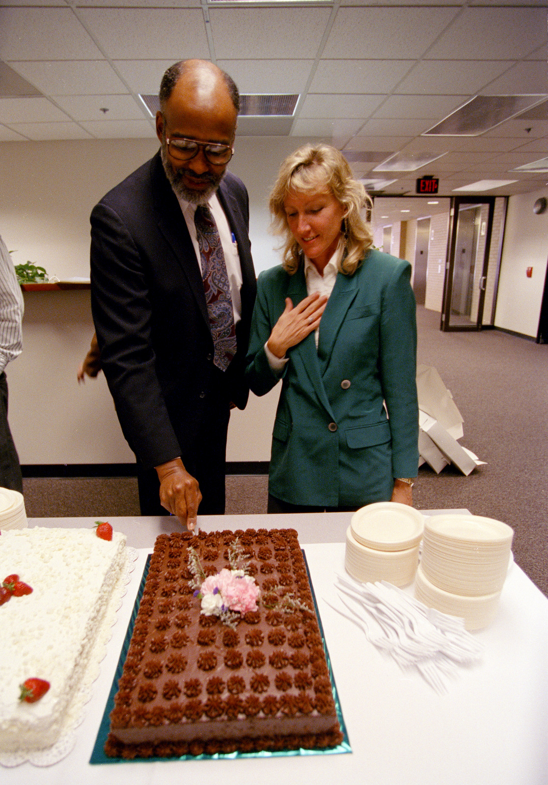 Leon Dash cuts a cake as photographer Carol Guzy looks on at the Post, April, 1995, after it was announced they both won Pulitzer Prizes. (AP/Greg Gibson)