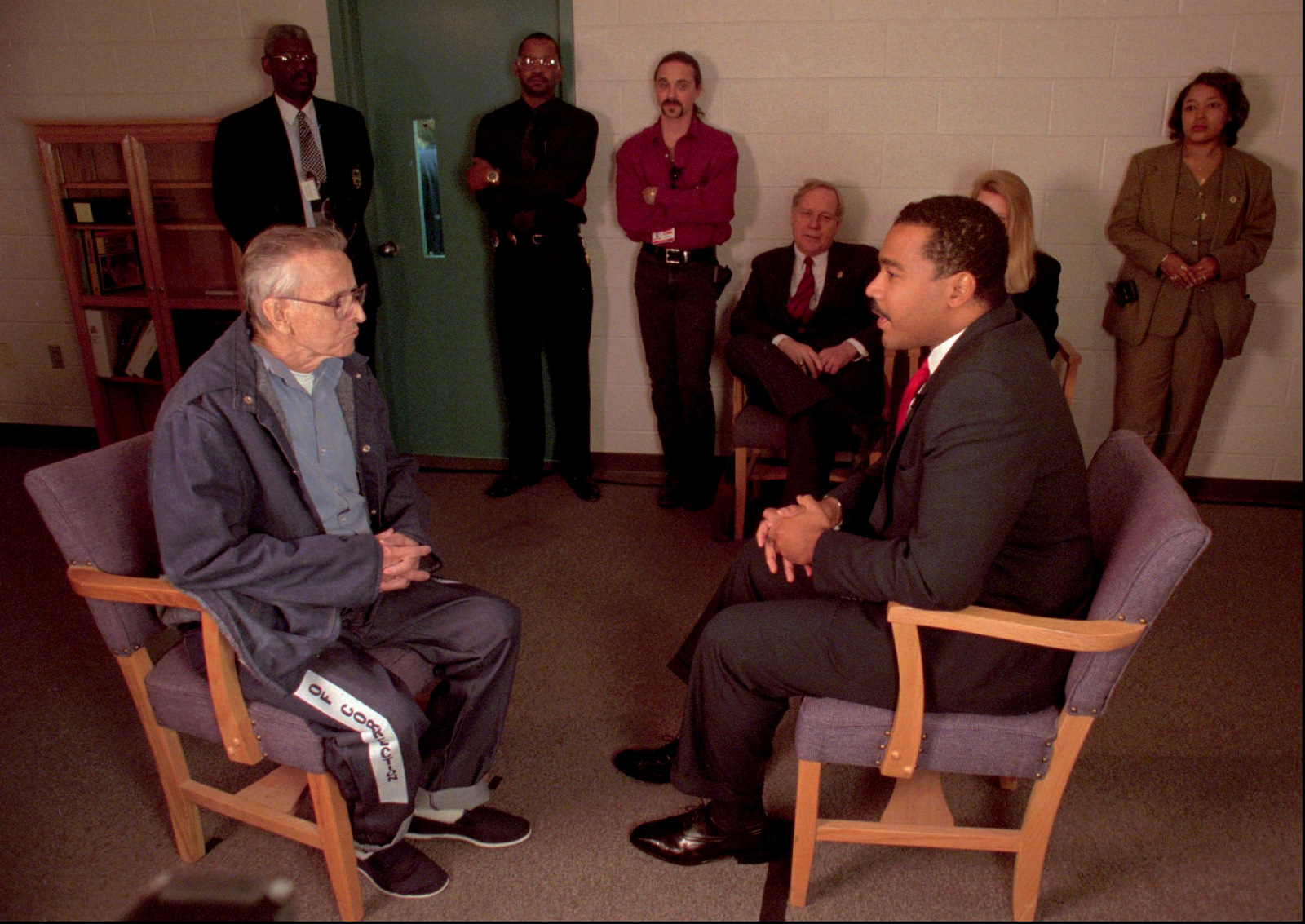 Dexter King, son of Martin Luther King Jr., meets with James Earl Ray, the man who confessed to killing King Sr. in 1969, in Nashville, Tenn., on March 27, 1997. During their meeting in a prison conference room, Ray denied killing King Sr. and Dexter King replied, "I believe you and my family believes you." (AP/Earl Warren/State of Tennessee)