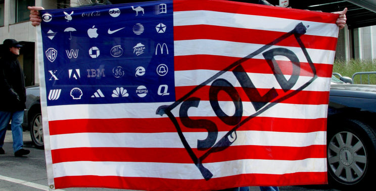 Protester holding Adbuster's Corporate American Flag at Bush's 2nd inauguration, Washington DC.