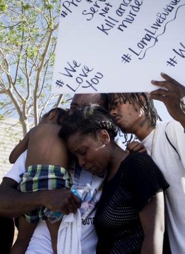 Friends and family of Diante "Butchie" Yarber mourn as protesters filled the parking lot of the Barstow (CA) police department on Tuesday April 10, 2018. Yarber was shot and killed by a Barstow Police Department Officer on April 5.(James Quigg/Daily Press via AP)
