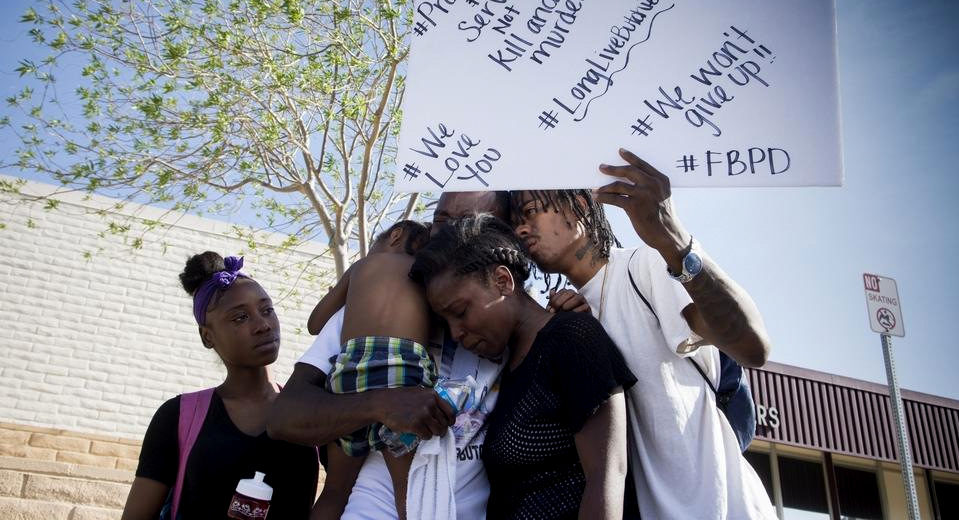 Friends and family of Diante "Butchie" Yarber mourn as protesters filled the parking lot of the Barstow (CA) police department on Tuesday April 10, 2018. Yarber was shot and killed by a Barstow Police Department Officer on April 5.(James Quigg/Daily Press via AP)