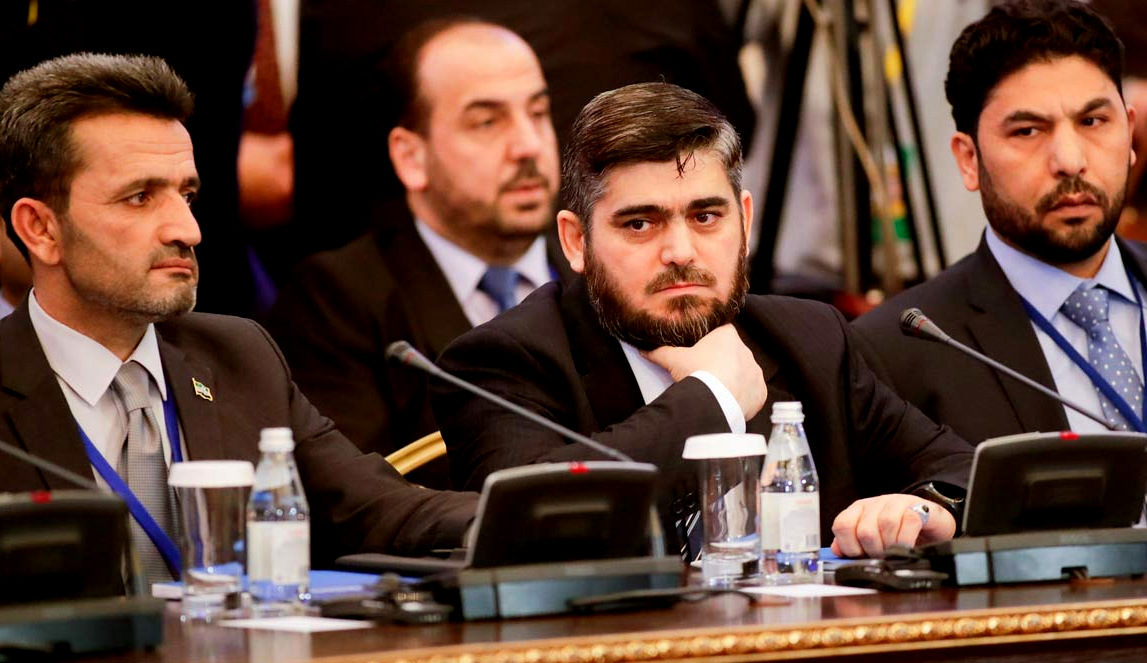 Mohammed Alloush, center, head of a Syrian opposition delegation, and other members attend talks on Syrian peace in Astana, Kazakhstan, Monday, Jan. 23, 2017. (AP Photo/Sergei Grits)
