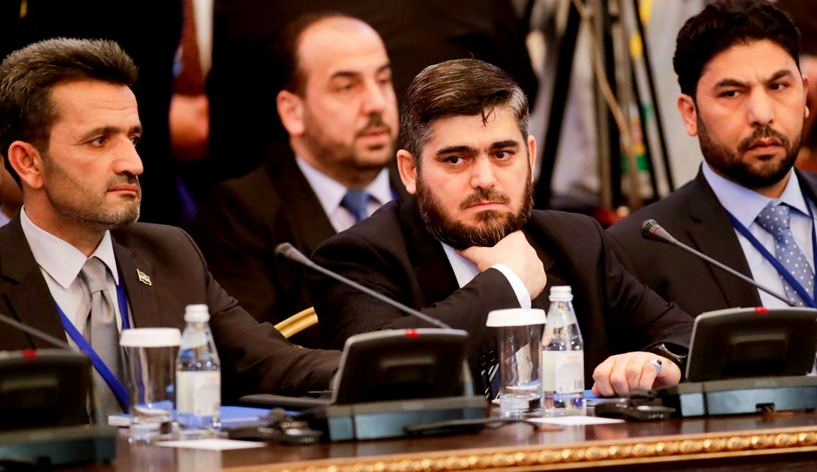 Mohammed Alloush, center, head of a Syrian opposition delegation, and other members attend talks on Syrian peace in Astana, Kazakhstan, Monday, Jan. 23, 2017. (AP Photo/Sergei Grits)