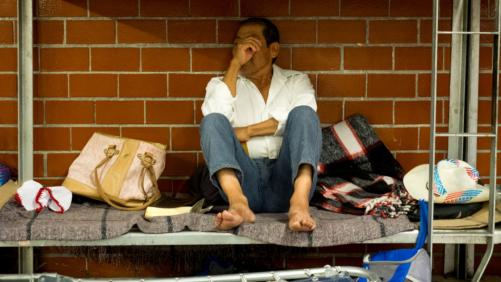 A migrant rests in his bunk at the Casa del Peregrino in Mexico City, April 10, 2018. 