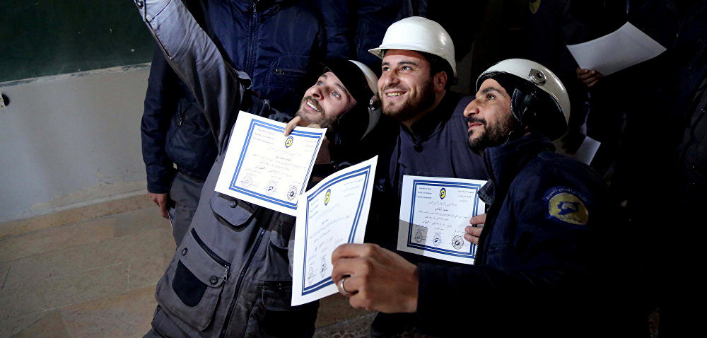 Members of the Syrian Civil Defense also known as the White Helmets pose for a photo.