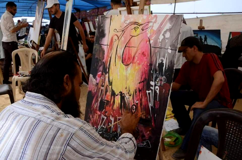 Ismaeel Dahlan paints his phoenix, inspired the Great Return protests in Gaza. (Photo: Karim Naser)
