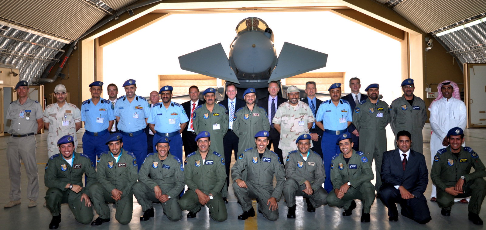 British military personell and employees of BAE systems pose with Saudi Air Force pilots in front of a British-made Typhoon.