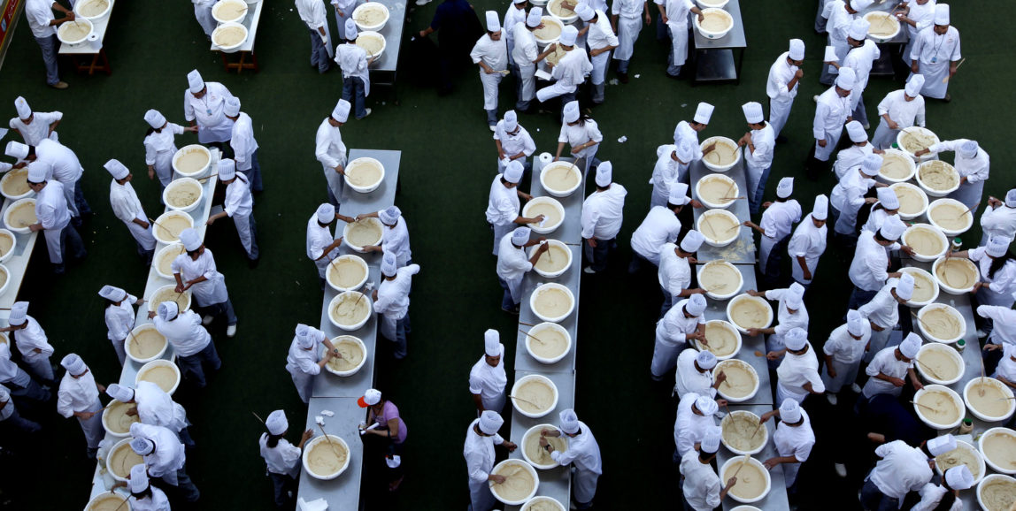 Lebanese chefs prepare hummus, during a bid to break a record previously held by Israel and reclaim ownership over the popular Middle Eastern dish, in Fanar, east of Beirut, Lebanon, Saturday May 8, 2010. Some 300 Lebanese chefs prepared the huge hummus plate weighing 22,046 pounds or 10,452 kilograms _ the size of Lebanon in square kilometers and doubled the record achieved by cooks in an Arab town near Jerusalem in January that weighed around four metric tons and broke a previous record held by Lebanon. A Guinness World Records adjudicator confirmed that Lebanon now holds the record. (AP Photo/Hussein Malla)