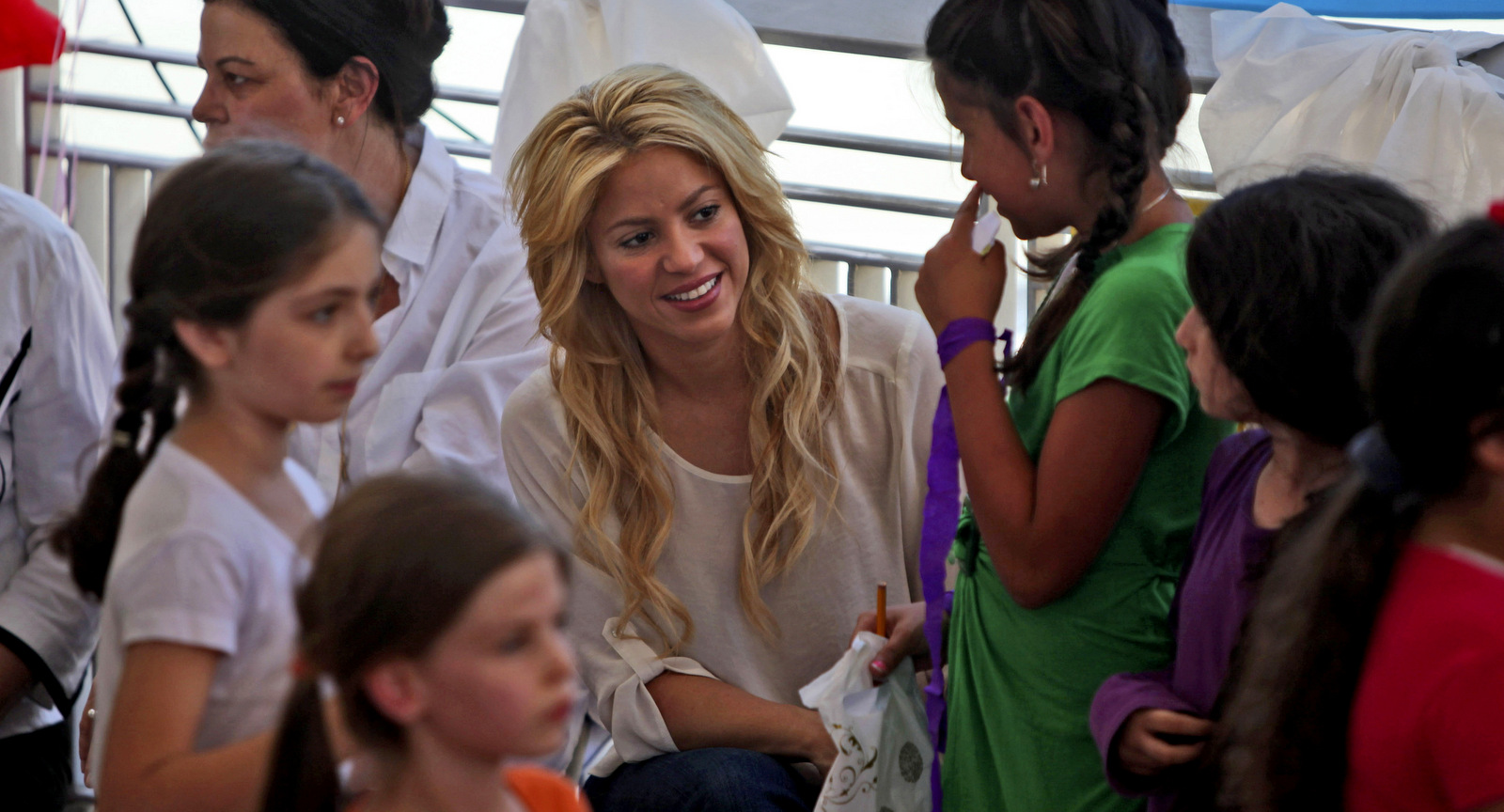 Colombian singer Shakira, center, visits a school in Jerusalem, Tuesday, June 21, 2011. Shakira is attending the Presidential Conference, sponsored by Israeli President Shimon Peres and will take part in panel alongside comedian Sarah Silverman. (AP Photo/Tara Todras-Whitehill)