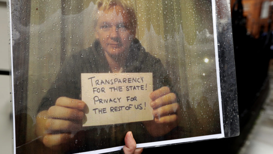 An Assange supporter holds a banner during a protest at the Ecuadorian embassy in London, March 29, 2018. (AP/Kirsty Wigglesworth)