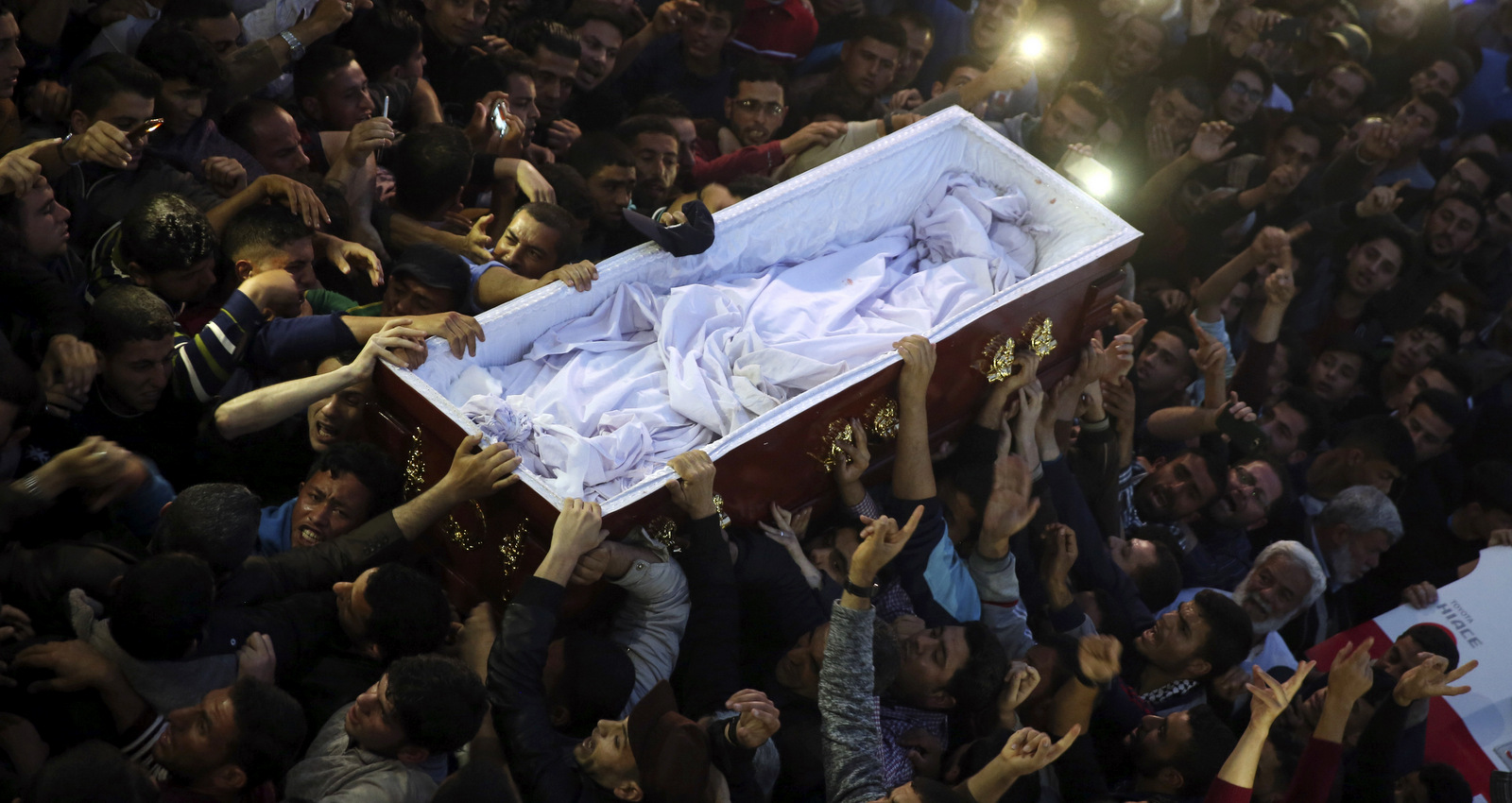 Mourners chant slogans while carry the coffin of Palestinian scientist Fadi al-Batsh, after his body crossed into the Gaza Strip from Egypt, during his funeral at Al Emari mosque in Jebaliya on Thursday, April 26, 2018. The body of the Hamas engineer who was gunned down in Malaysia last week was returned for burial. (AP Photo/Adel Hana)