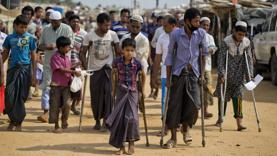 Wounded Rohingya refugees walk with the help of crutches as they await the arrival of a U.N. Security Council team at the Kutupalong Rohingya refugee camp in Kutupalong, Bangladesh, Sunday, April 29, 2018. A U.N. Security Council team visiting Bangladesh promised Sunday to work hard to resolve a crisis involving hundreds of thousands of Rohingya Muslims who have fled to the country to escape military-led violence in Myanmar. (AP/A.M. Ahad)