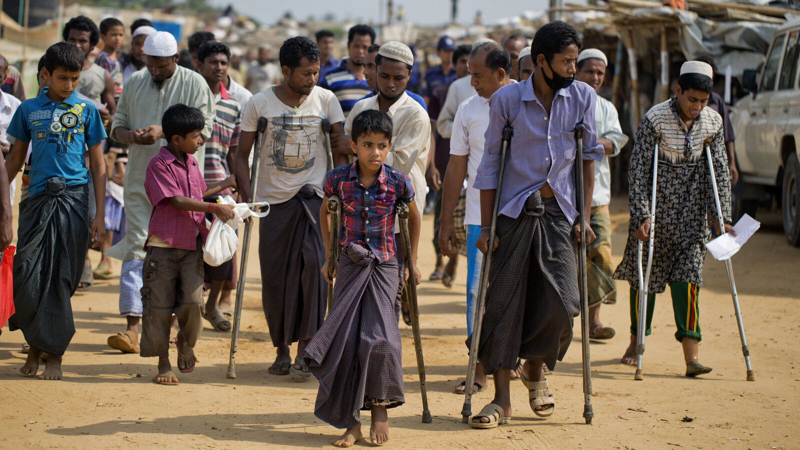 Wounded Rohingya refugees walk with the help of crutches as they await the arrival of a U.N. Security Council team at the Kutupalong Rohingya refugee camp in Kutupalong, Bangladesh, Sunday, April 29, 2018. A U.N. Security Council team visiting Bangladesh promised Sunday to work hard to resolve a crisis involving hundreds of thousands of Rohingya Muslims who have fled to the country to escape military-led violence in Myanmar. (AP/A.M. Ahad)