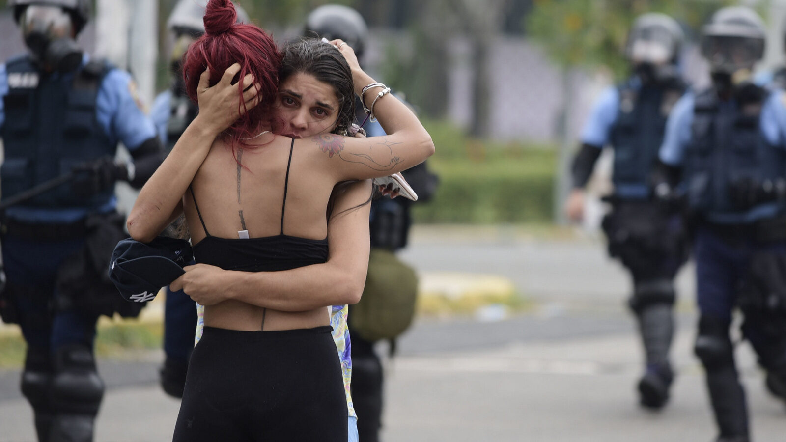 Two women embrace after a May Day march turned violent, in San Juan, Puerto Rico, May 1, 2018. (AP/Carlos Giusti)