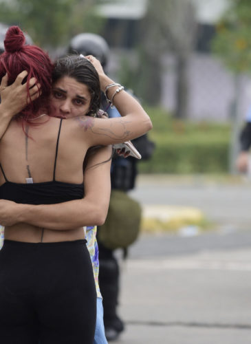 Two women embrace after a May Day march turned violent, in San Juan, Puerto Rico, May 1, 2018. (AP/Carlos Giusti)