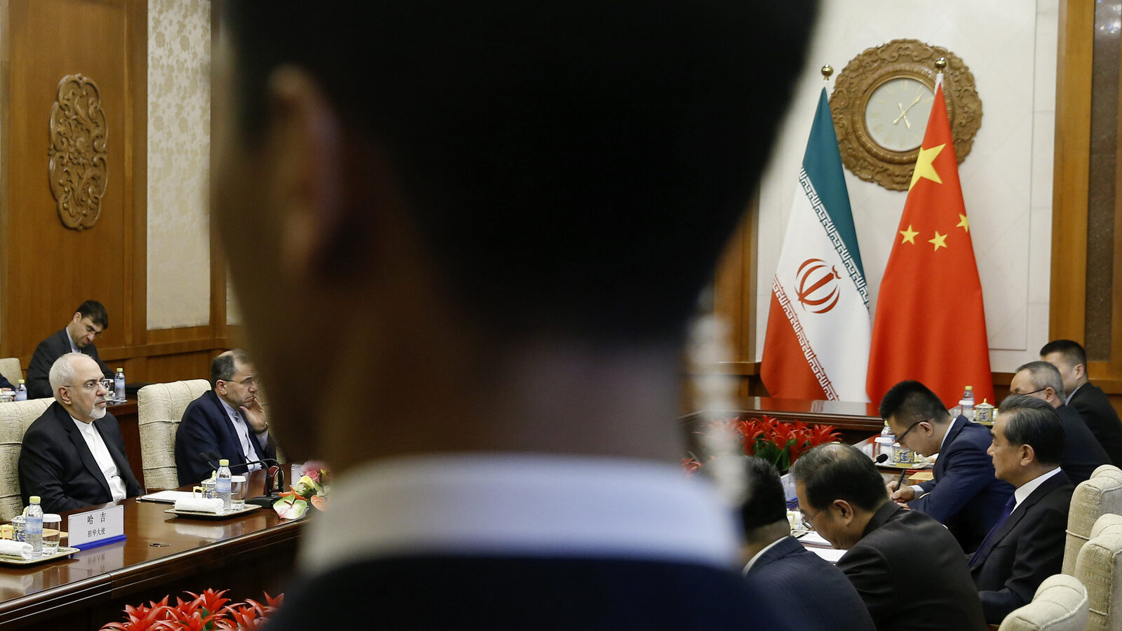 Chinese State Councillor and Foreign Minister Wang Yi, right, meets Iranian Foreign Minister Mohammad Javad Zarif at the Diaoyutai state guesthouse in Beijing, Sunday, May 13, 2018. (Thomas Peter/Pool Photo via AP)