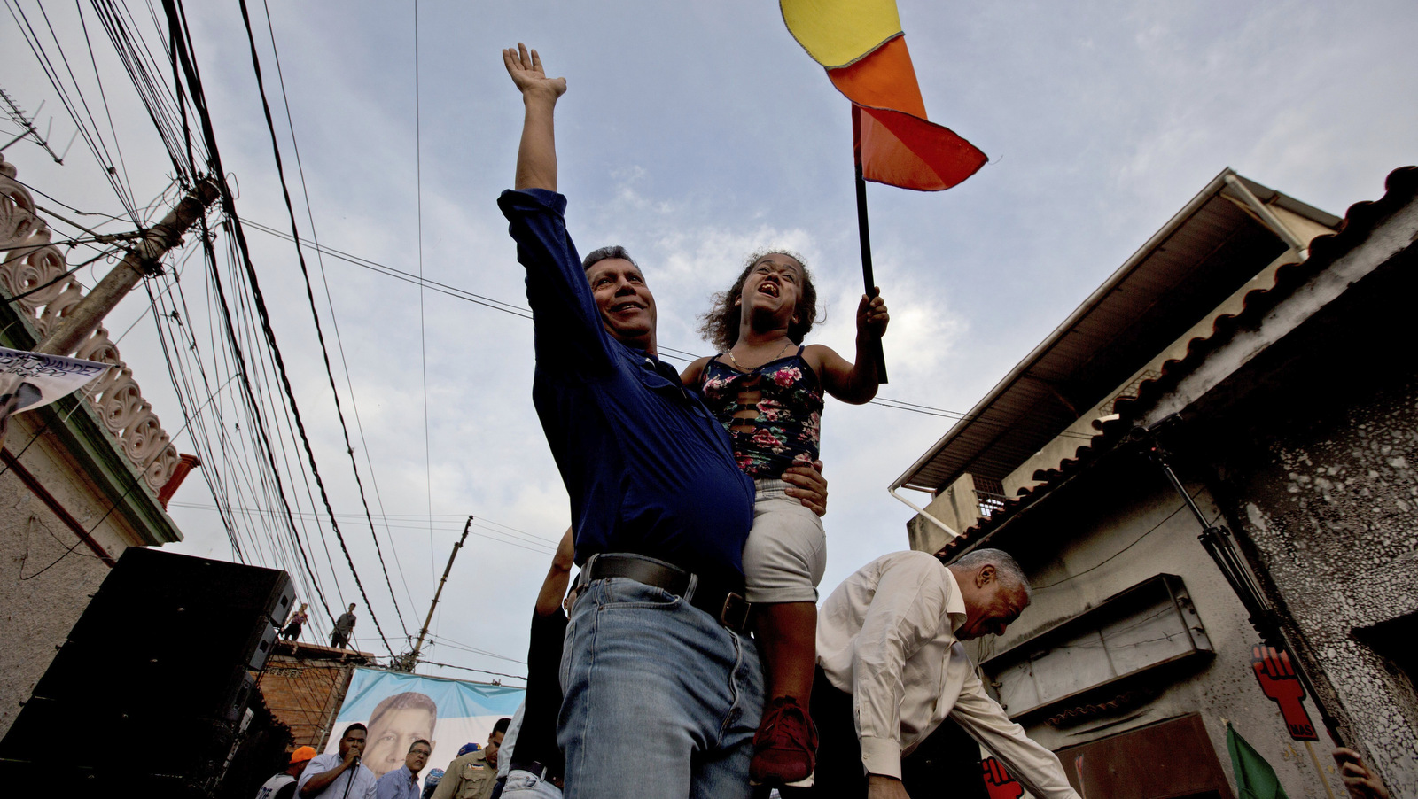 Henri Falcon, left, holds up a woman during a rally in Caracas, Venezuela, May 14, 2018. Fernando Llano | AP