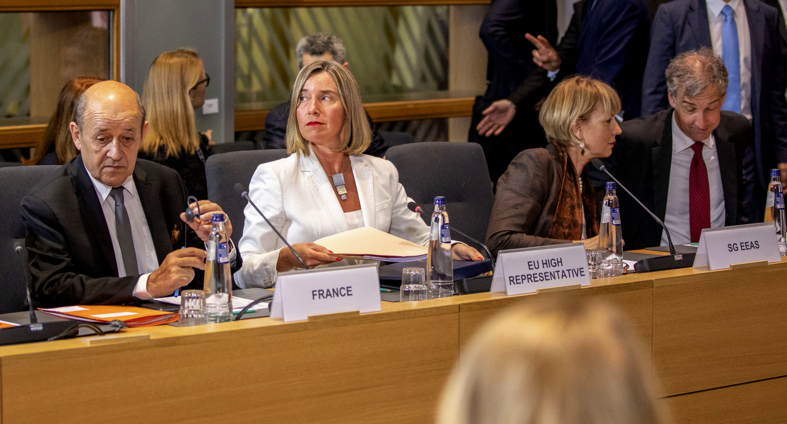 French Foreign Minister Jean-Yves Le Drian, left sits next to European Union foreign policy chief Federica Mogherini during a meeting of the foreign ministers from Britain, France and Germany with the Iran Foreign Minister at the Europa building in Brussels, May 15, 2018. (AP/Olivier Matthys)